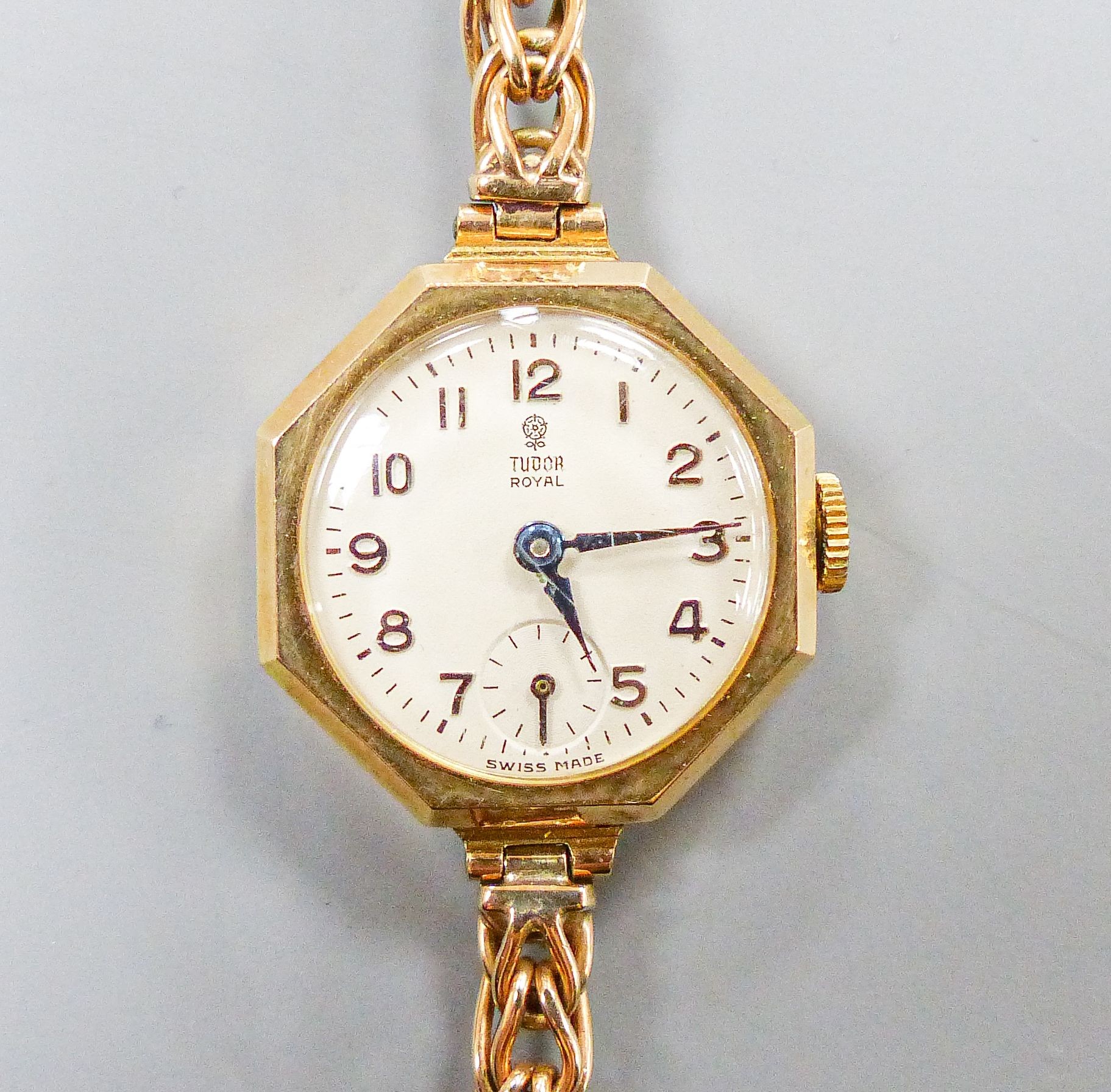 A ladys' vintage Tudor Royal 9ct gold manual wind wristwatch, having circular dial with subsidiary seconds dial in octagonal case, on a 9ct gold flexible link bracelet with safety clasp, in original box